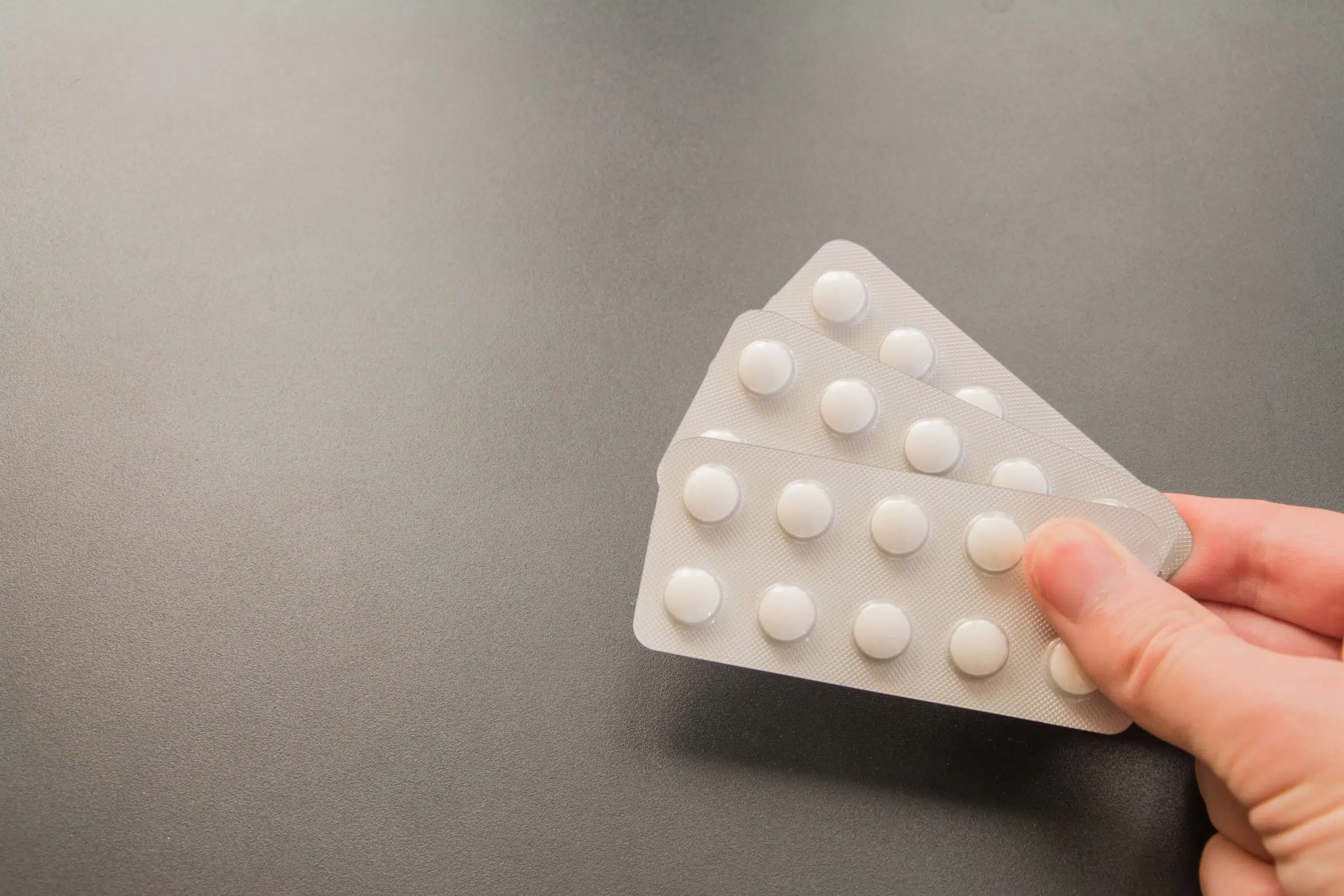 Contraceptive pills pack on gray background