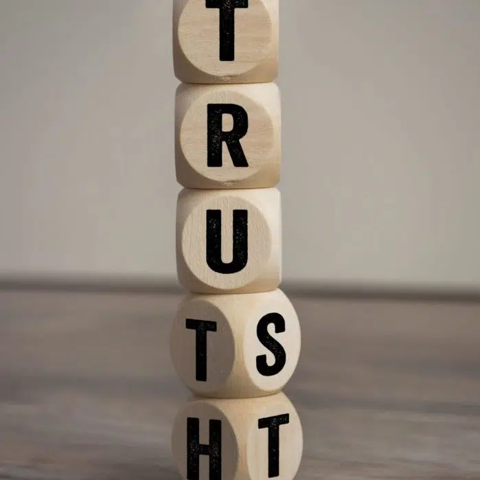 Cubes, dice or blocks with trust and truth on wooden background