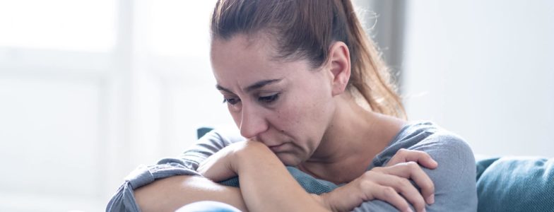 woman upset sad depressed sitting