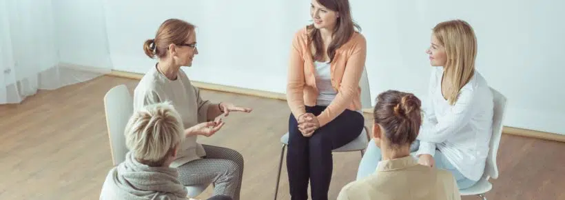 women meeting talking in support group - infertility support groups