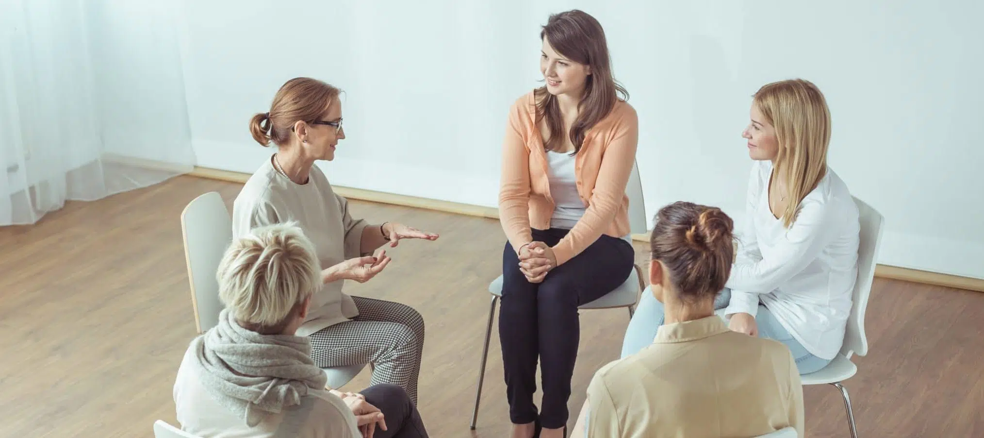 women meeting talking in support group - infertility support groups