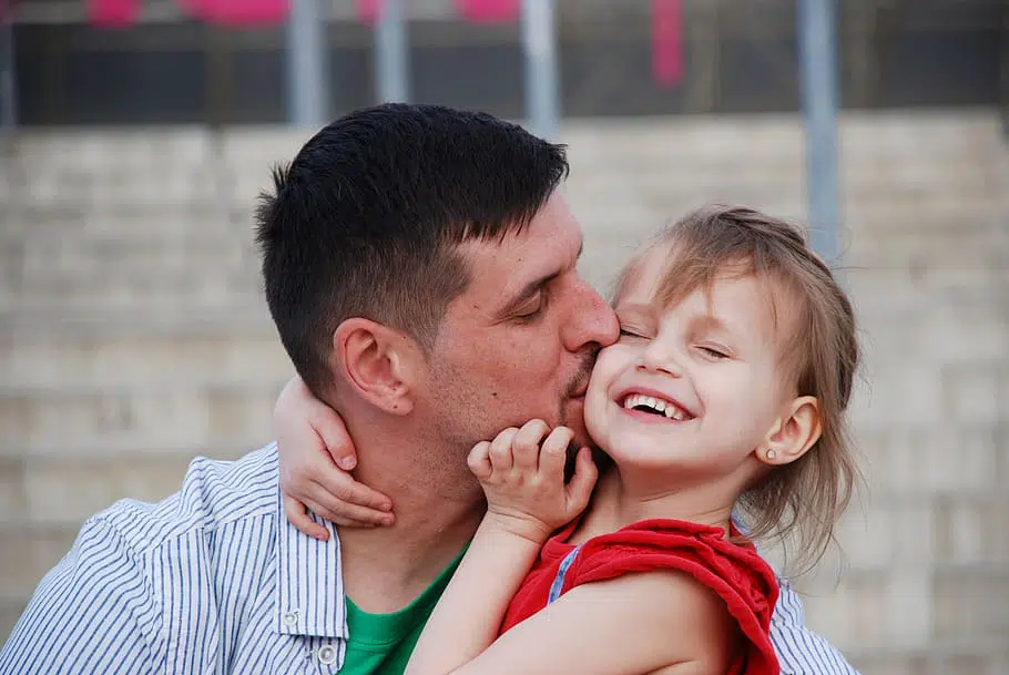 dad kissing his little girl