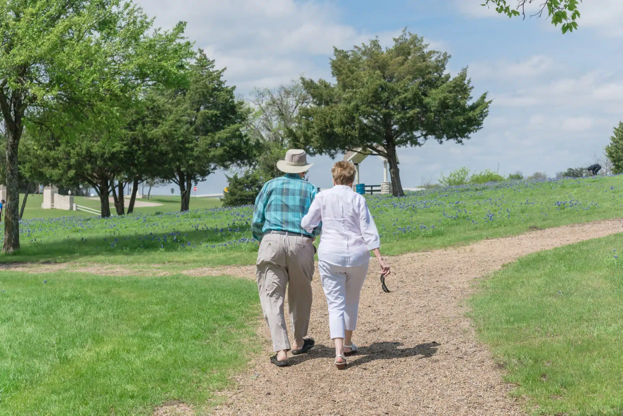 close-up elderly couple walking in park