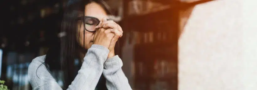 Woman pray with bible, Asian woman believe in the prayer to God, Christian student pray for study to pass the exam in the library at the college .Bible and christian study concept