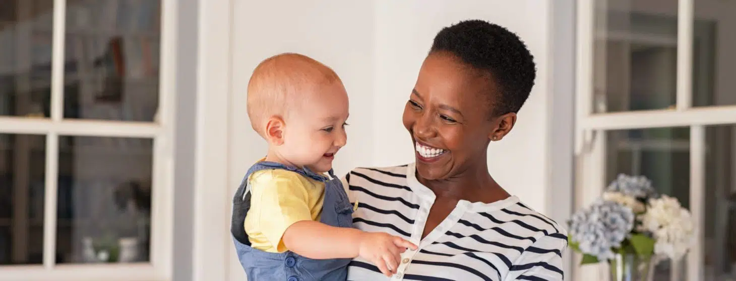 African mother holding adopted child