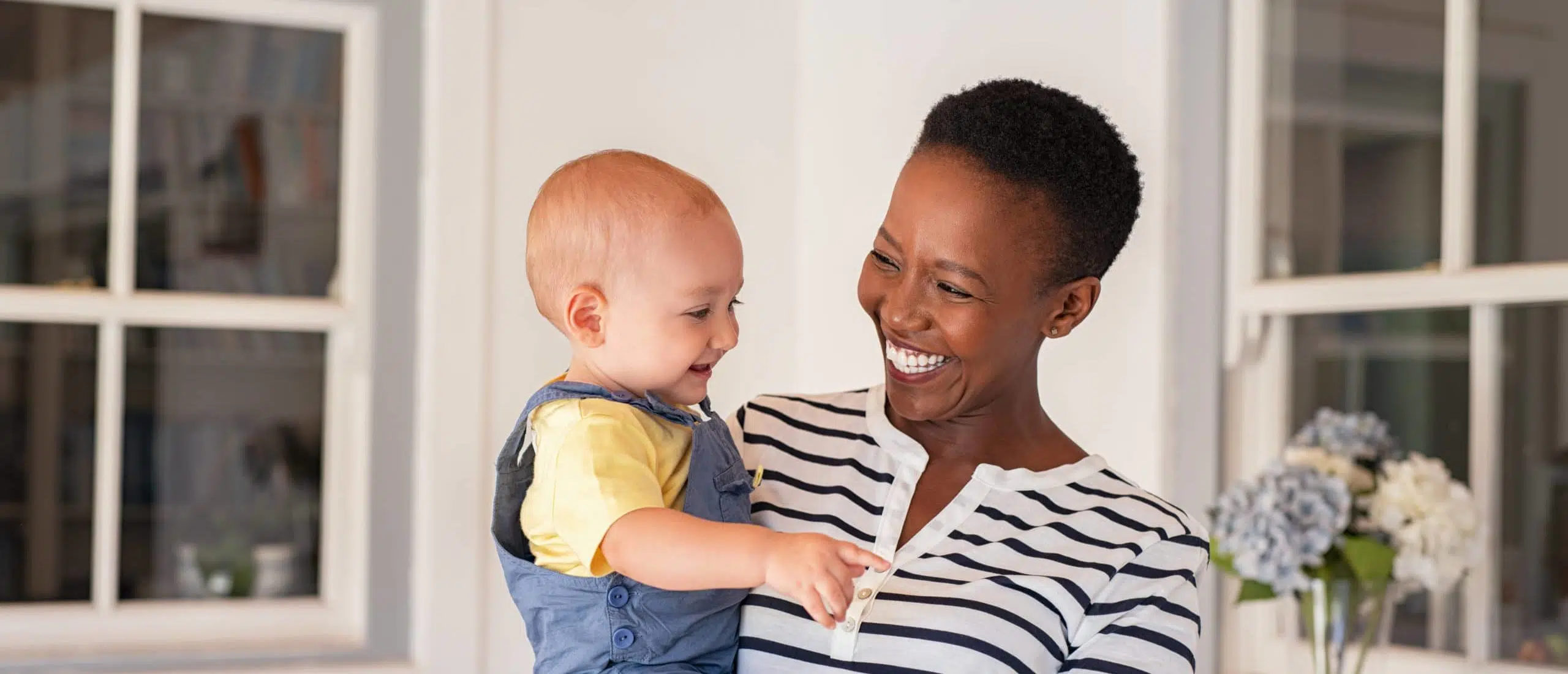 African mother holding adopted child - transgender parental rights
