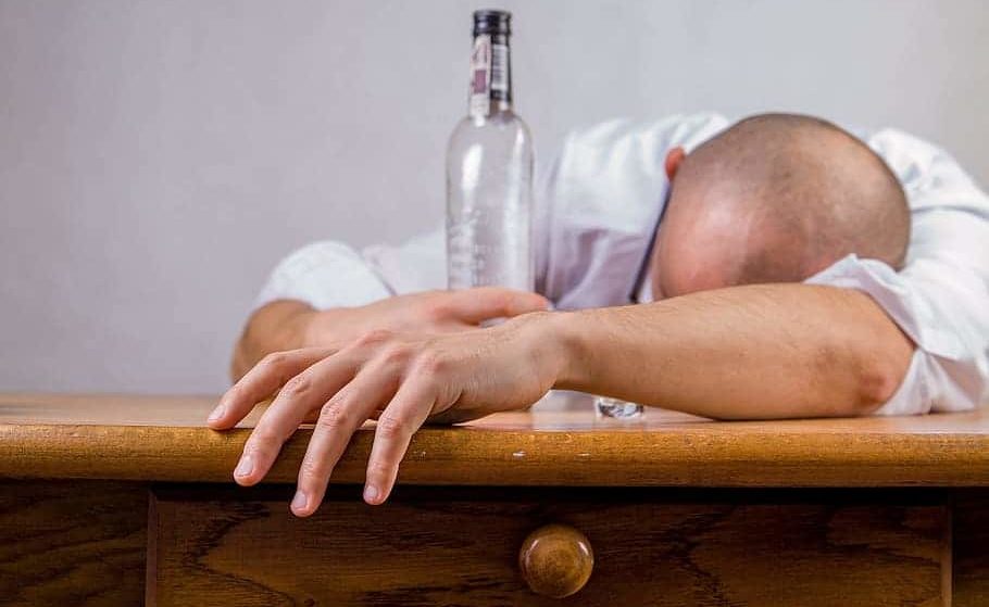 drunk man with empty bottle