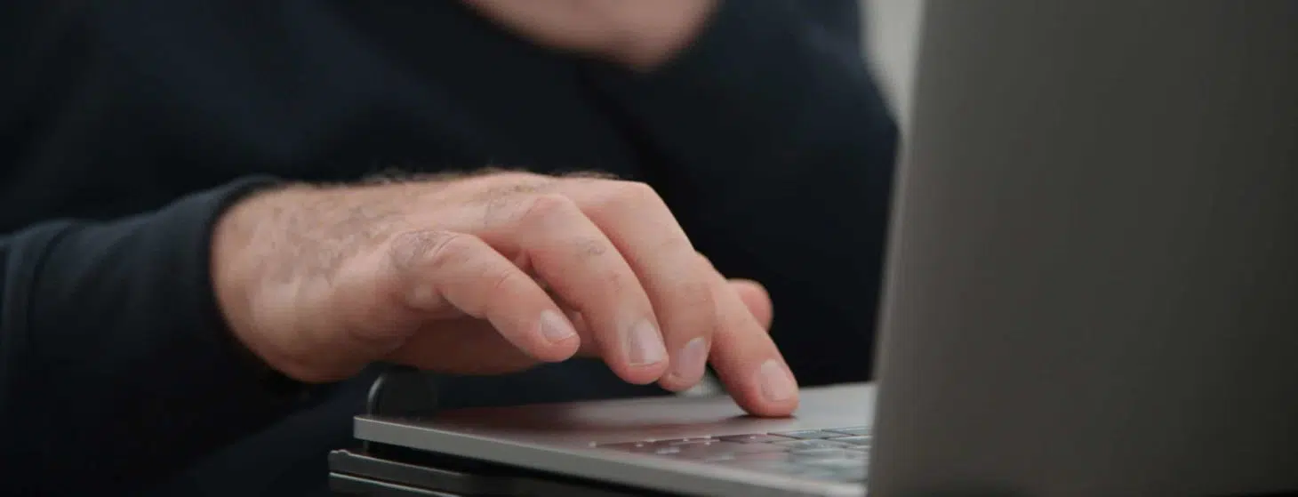 Man watching porn on laptop computer touching himself