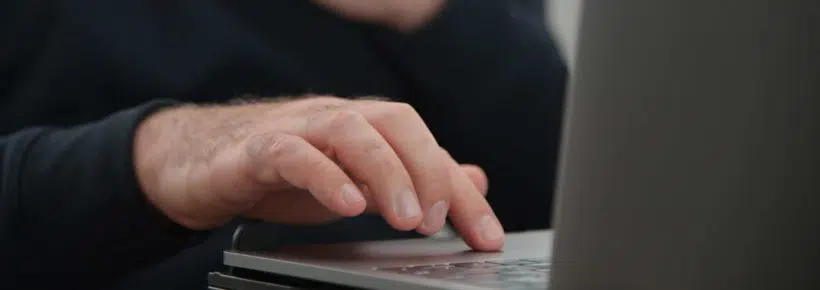 Man watching porn on laptop computer touching himself