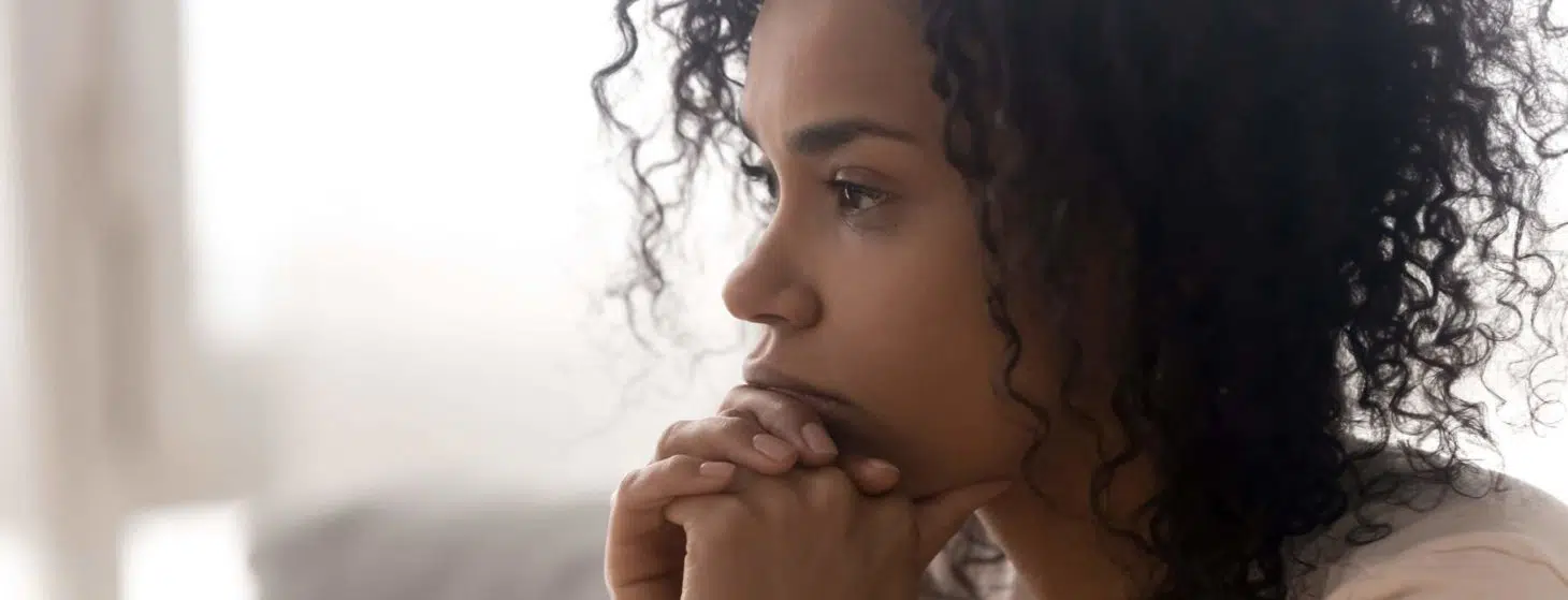 Close up side profile view of pensive young african American woman thinking of relationships problems, thoughtful black biracial female feel despair lost in thoughts consider life trouble or drama