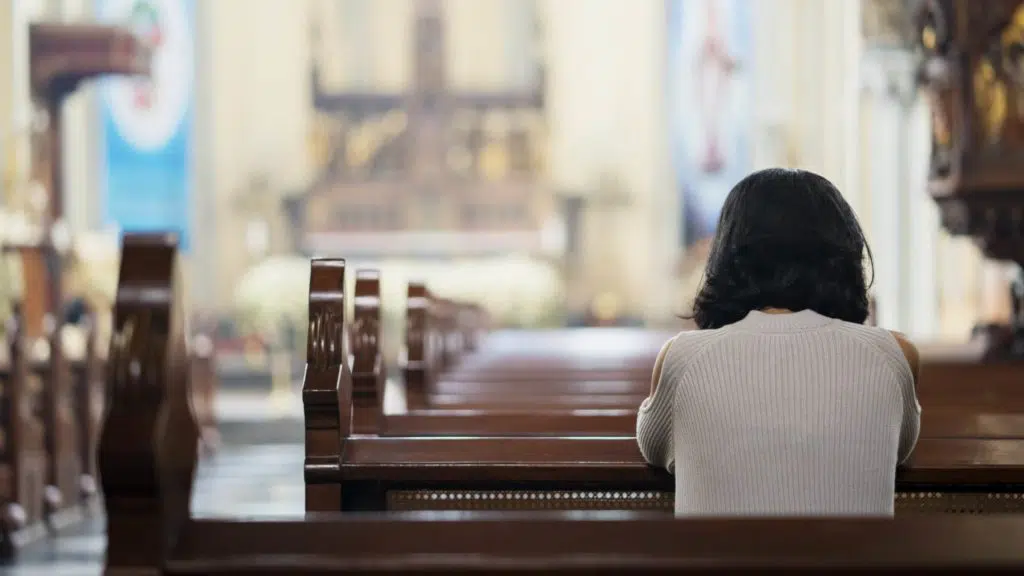 woman sitting in a catholic church