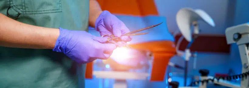 A doctor holds gynecological instruments in his hand. Examination by a gynecologist.