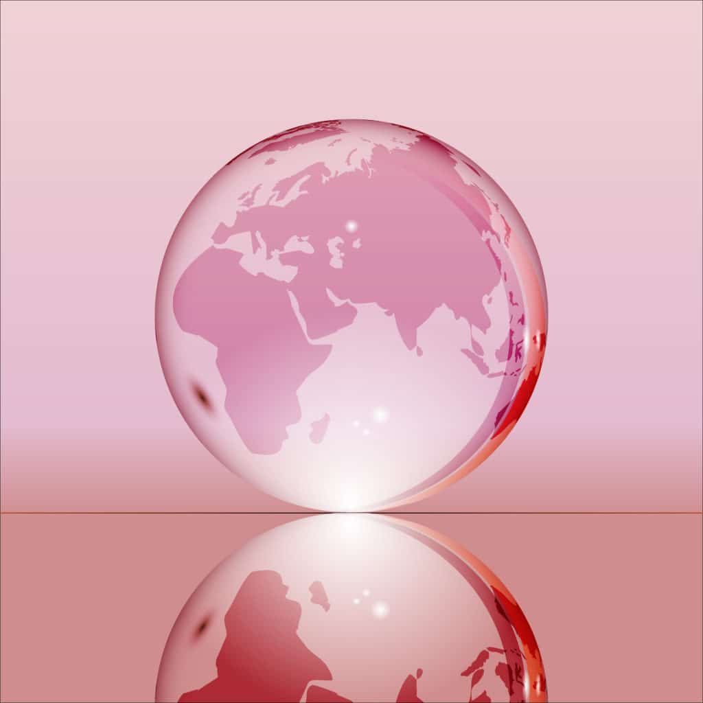 Pink shining transparent earth globe with Eurasia, Africa and Australia continents laying on glass surface and reflecting in it.