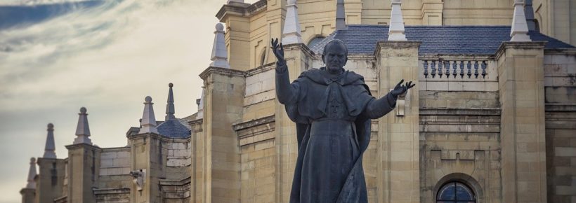 statue of john paul ii in front of a church