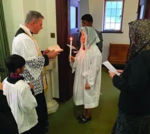 Asel receiving the sacrament of baptism