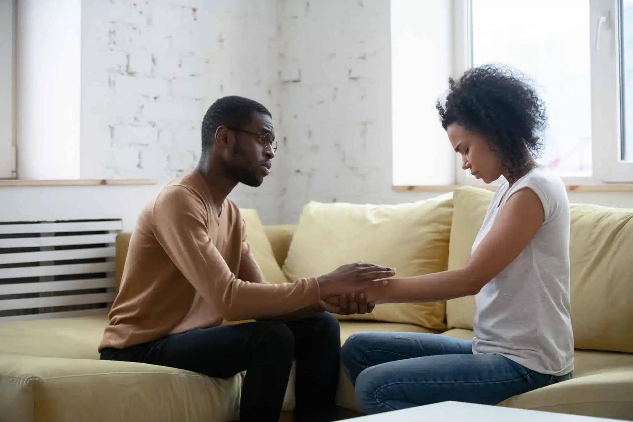 Grieving couple man giving support to sad woman