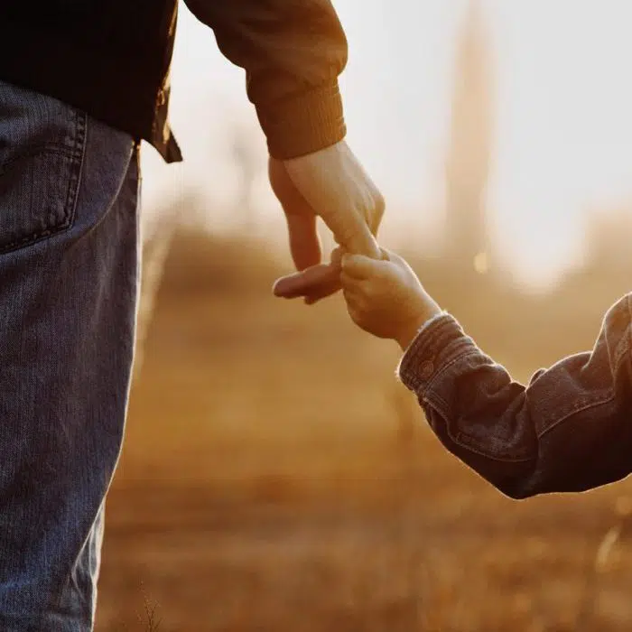 boy holding his dad's finger