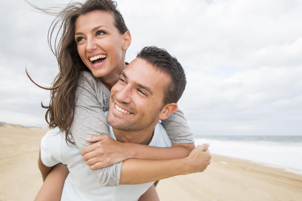 happy couple having fun on the beach