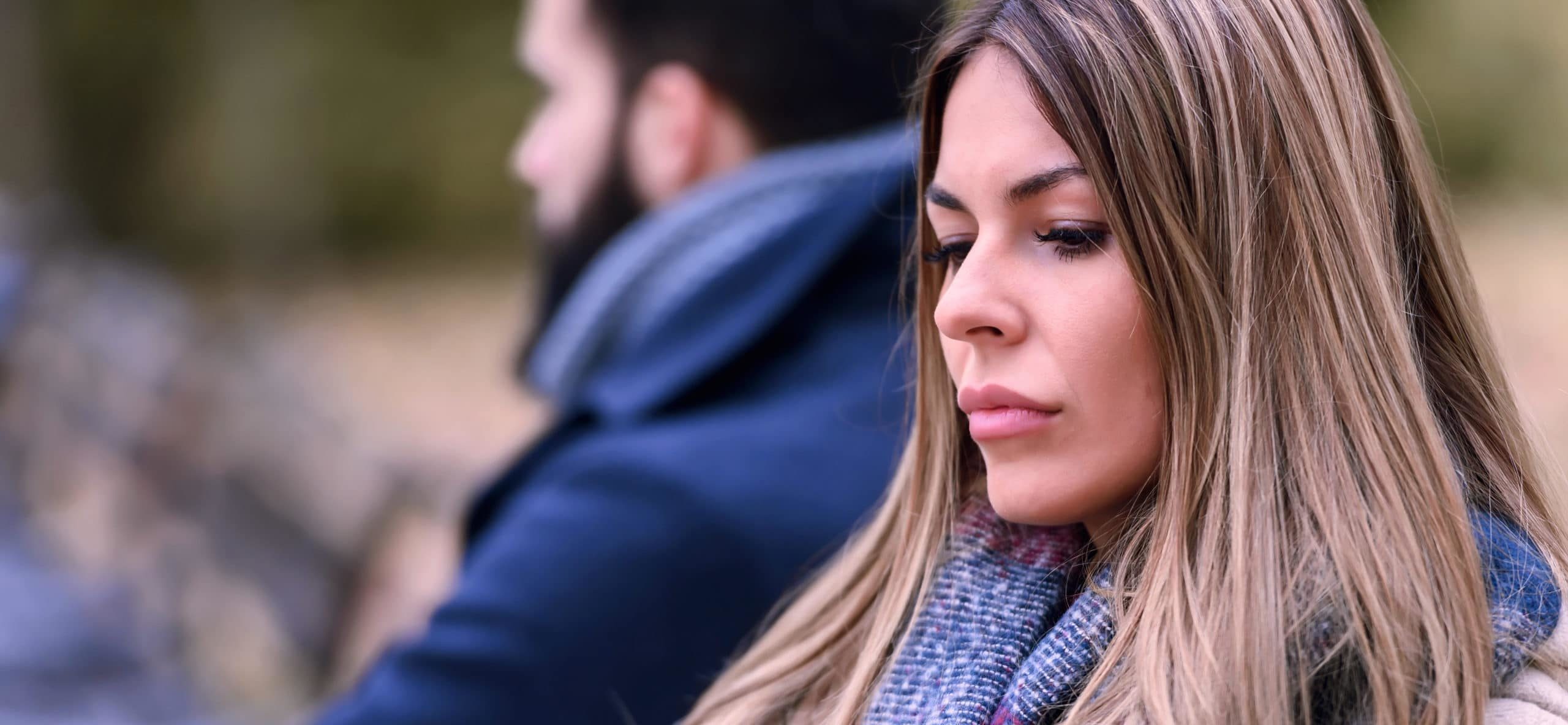 Couple sitting in park having problems