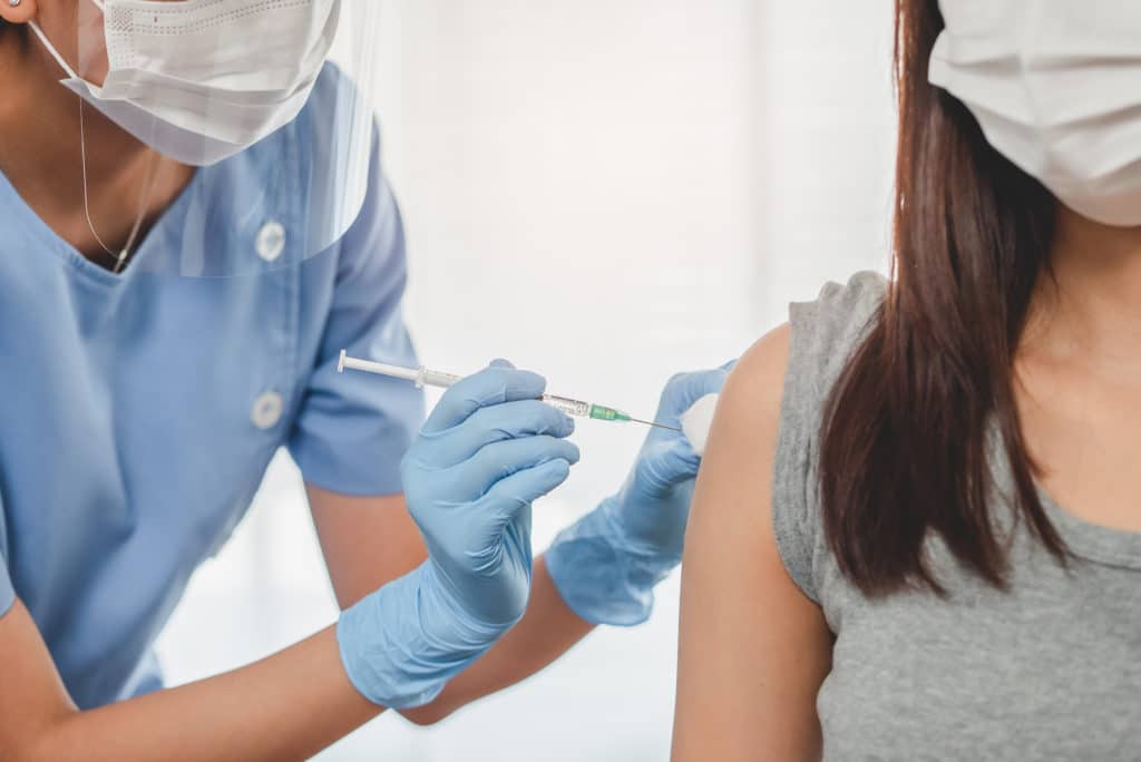 young woman getting a vaccine