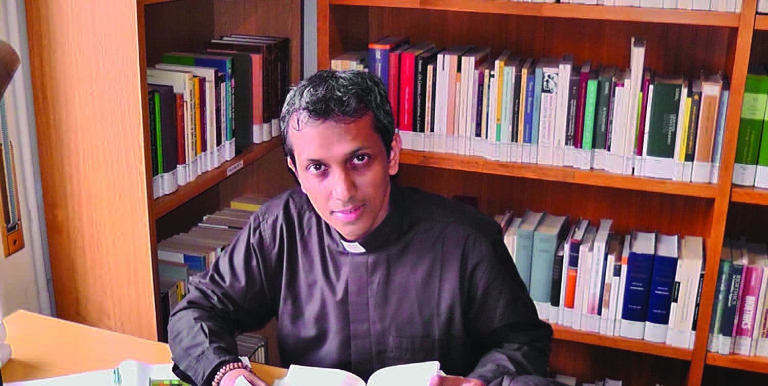 Fr. Joby studying in the HLI Bioethics Library