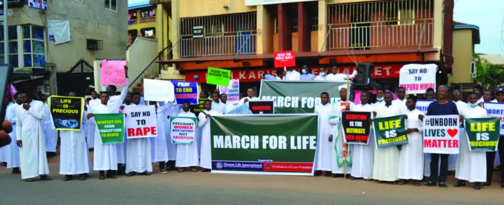 Seminarians marching with signs