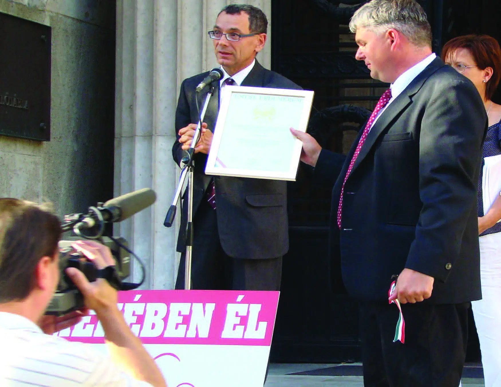 Dr. Imre and Judge Andras speak in front of a Hungarian government building