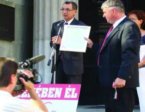Dr. Imre and Judge Andras speaking in front of a Hungarian government building