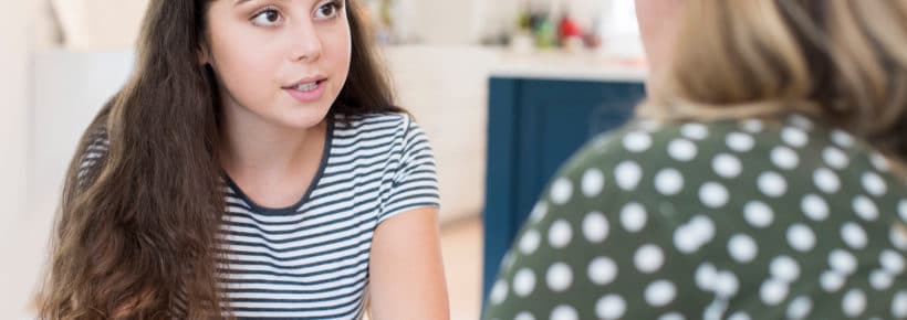 Mother Having Serious Conversation With Teenage Daughter At Home