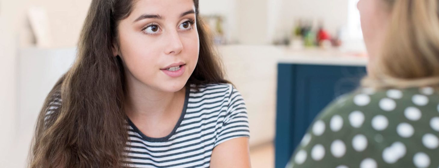 Mother Having Serious Conversation With Teenage Daughter At Home