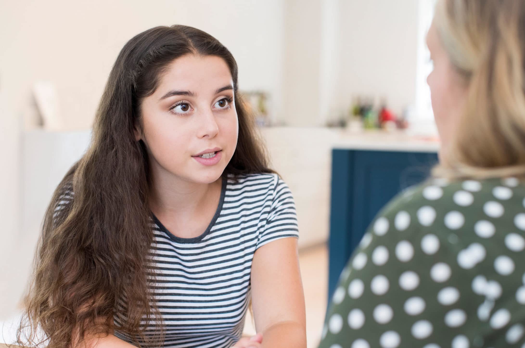 Mother Having Serious Conversation With Teenage Daughter At Home