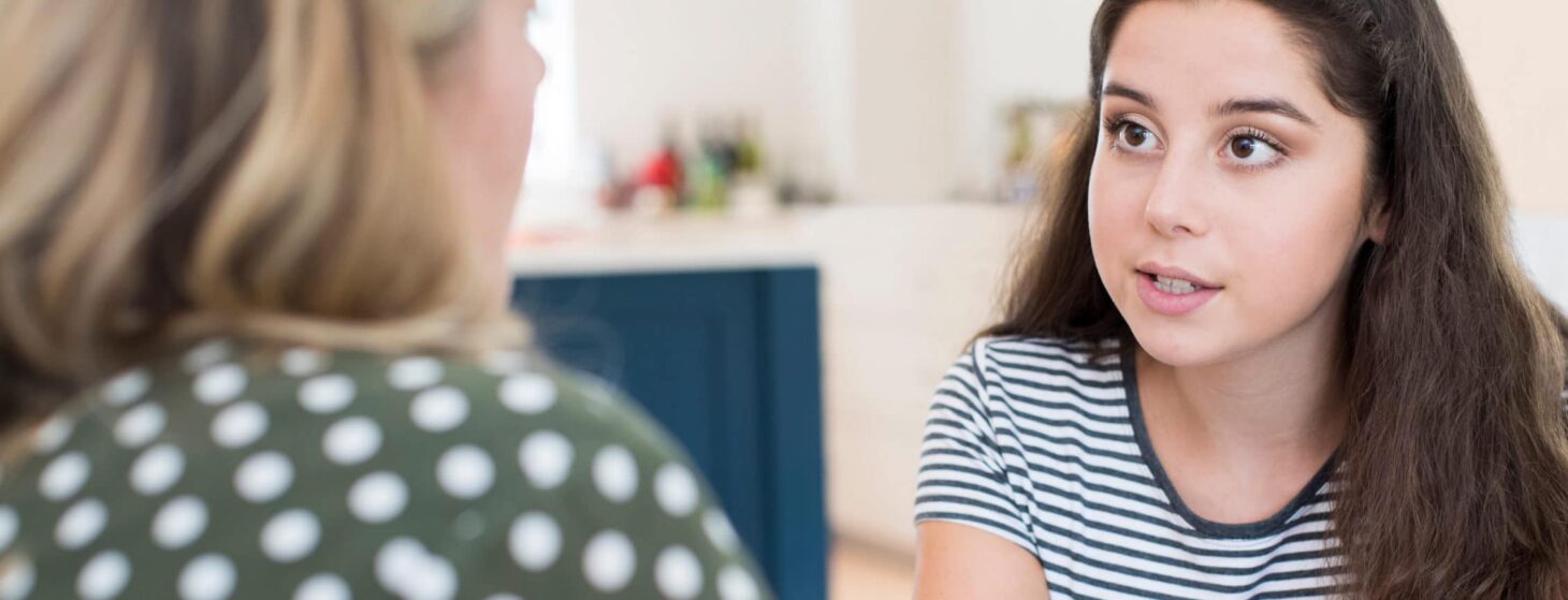 Mother Having Serious Conversation With Teenage Daughter At Home