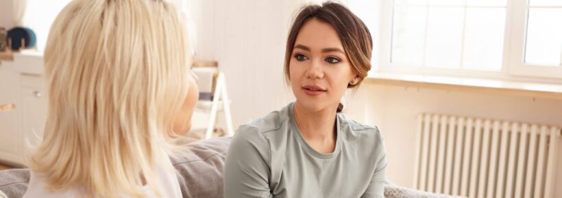 parent and young adult talking with coffee