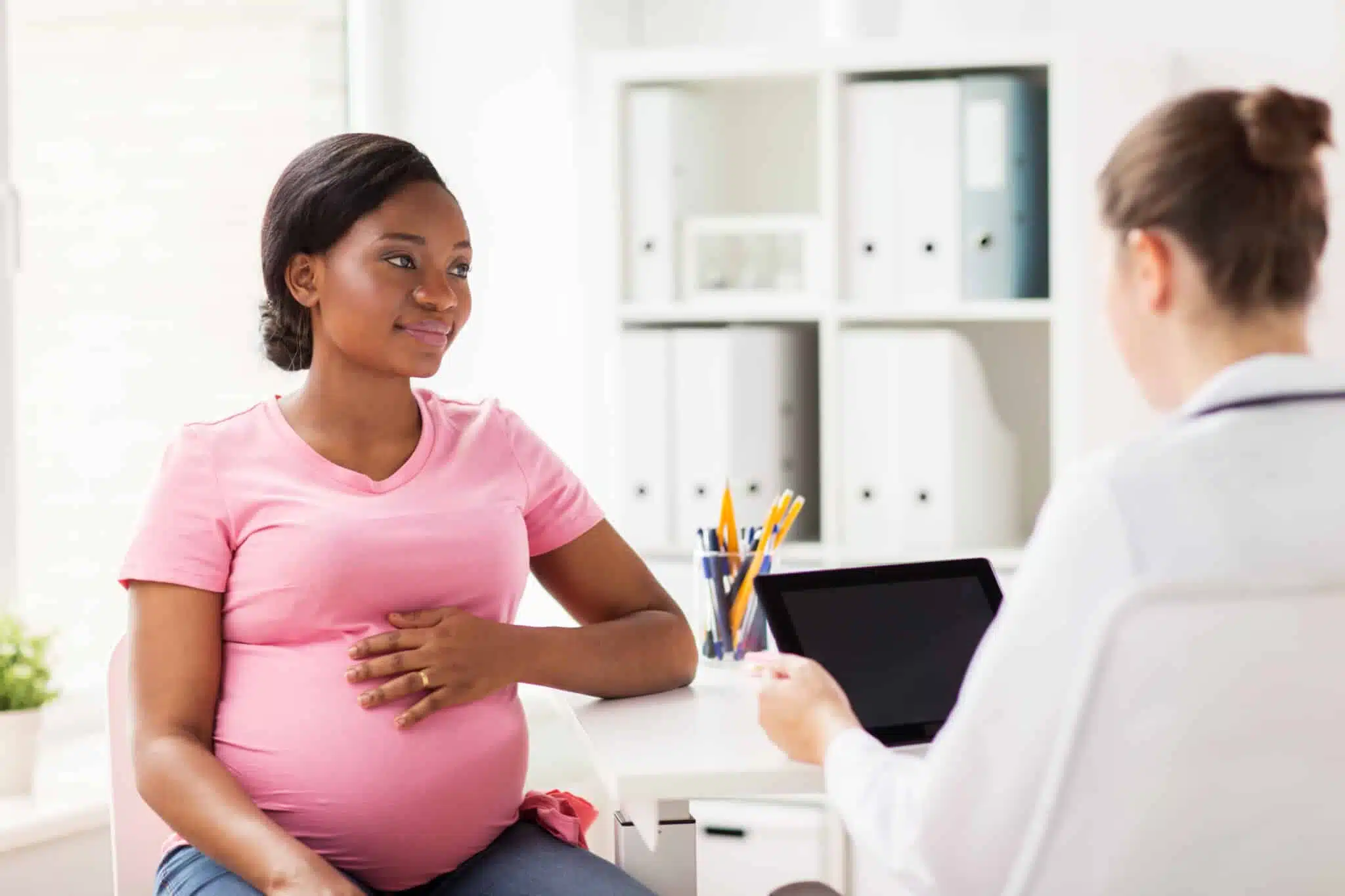 pregnant woman at clinic with doctor
