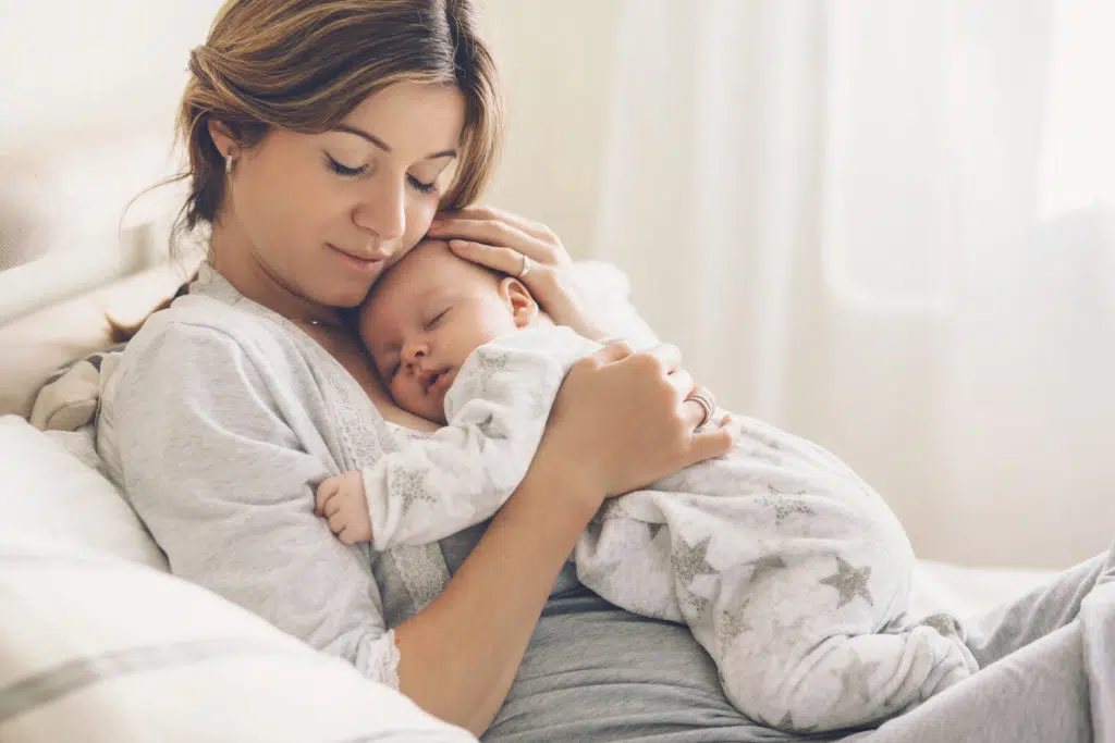 Happy mother holding her newborn baby