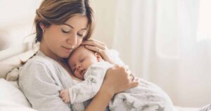 Happy mother holding her newborn baby