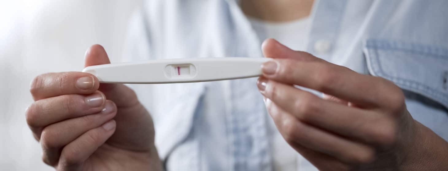 woman holding a negative pregnancy test