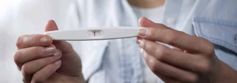 woman holding a negative pregnancy test