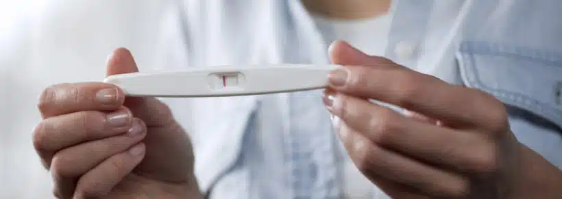 woman holding a negative pregnancy test