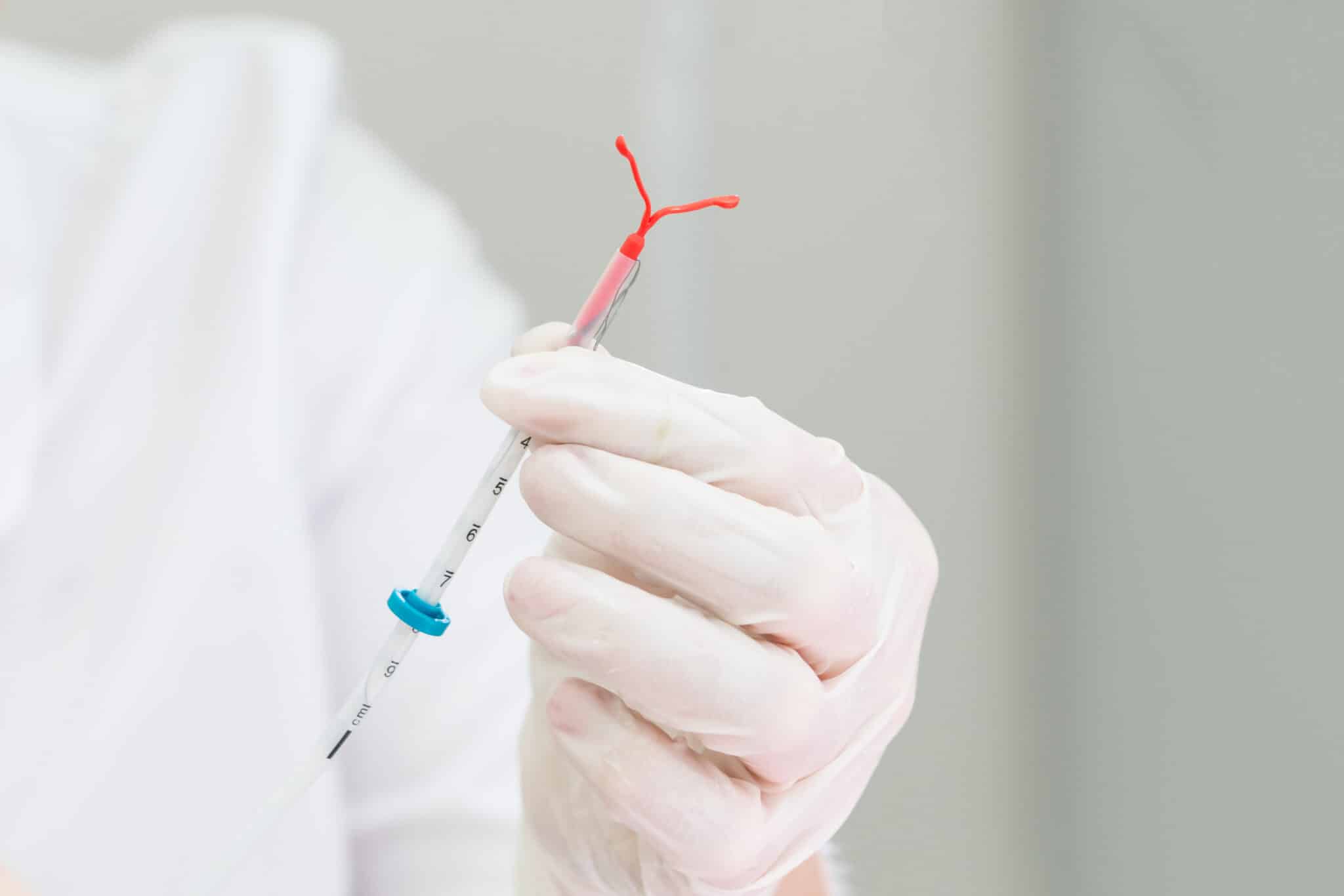 Gynecologist holding an IUD