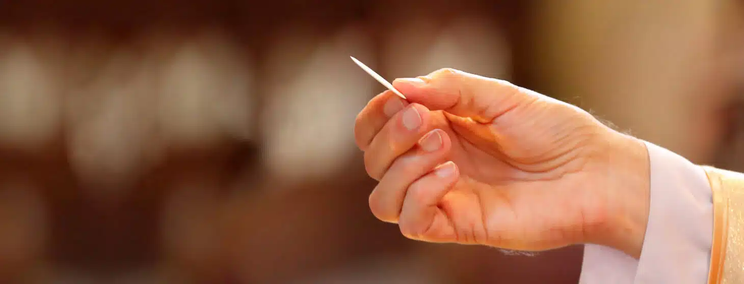 the hand of a priest distributing holy Communion