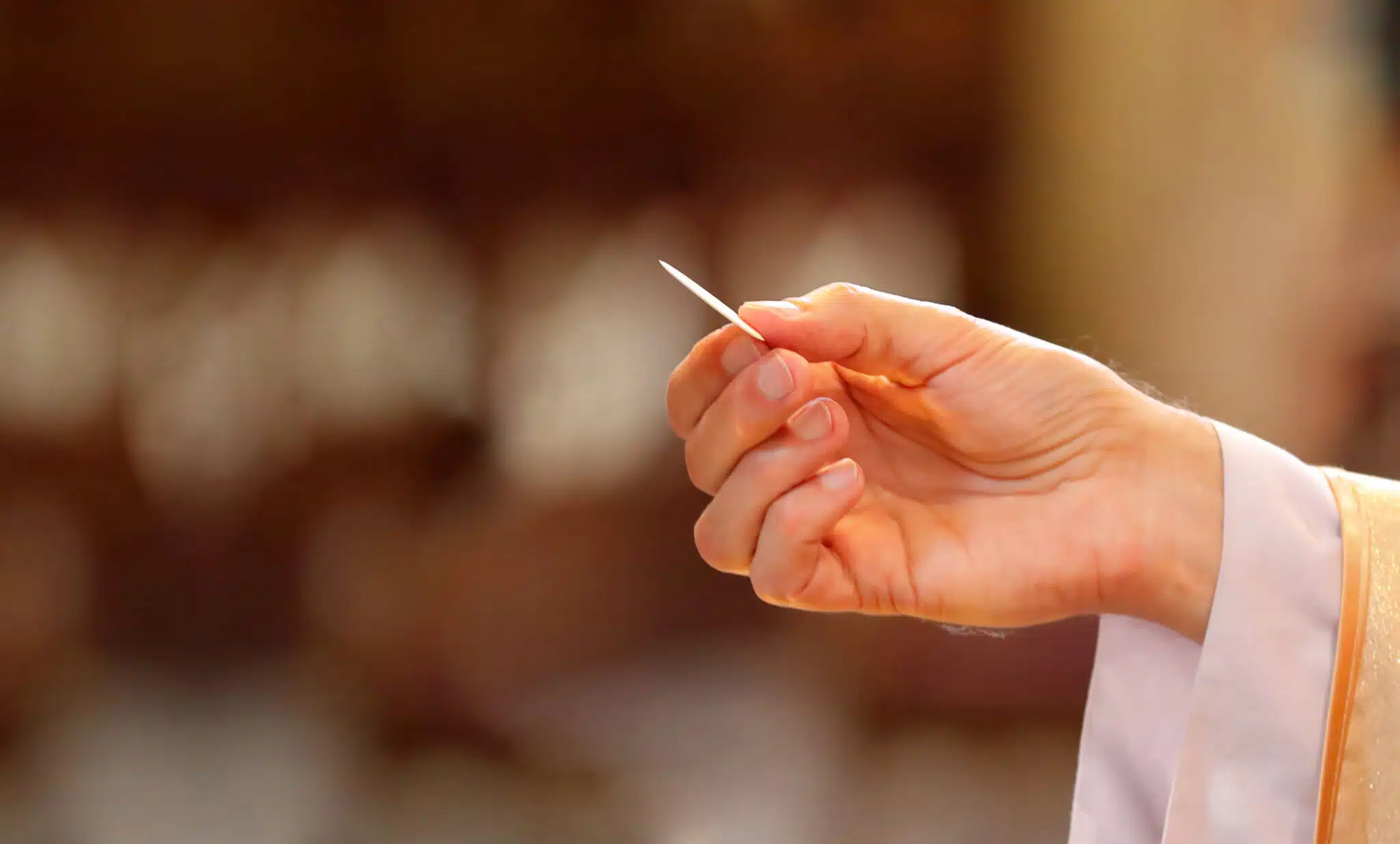 the hand of a priest distributing holy Communion