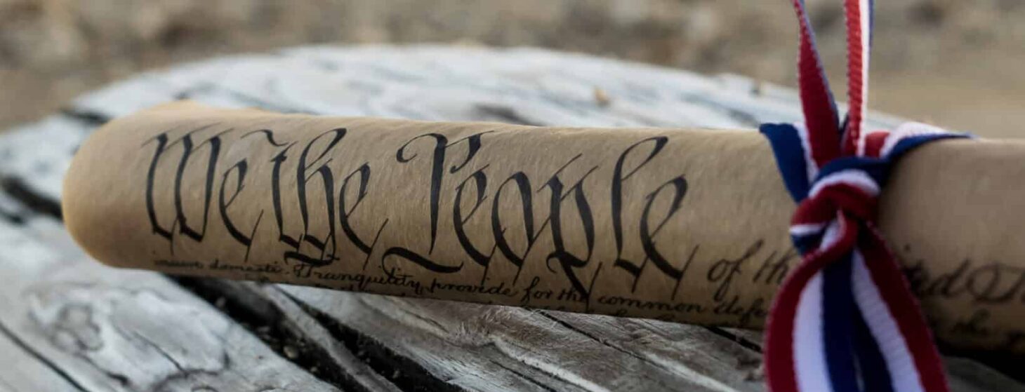 Constitution displaying "we the people" on a wooden table
