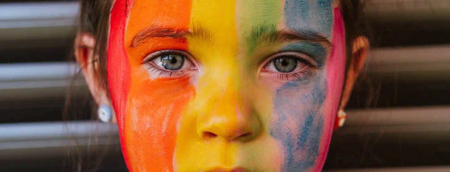 Child with rainbow painted face