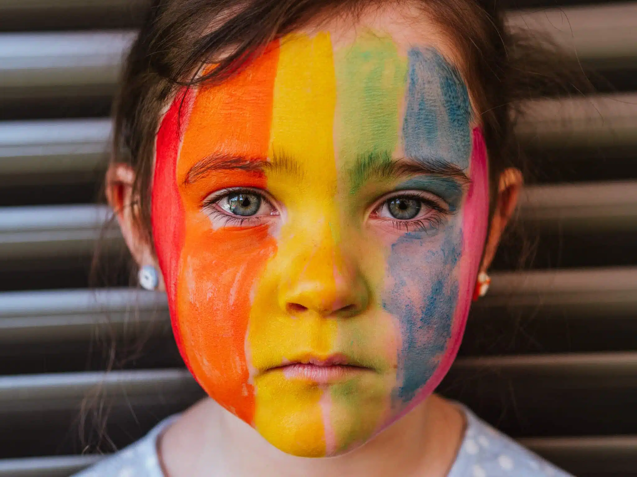 Child with rainbow painted face gender ideology