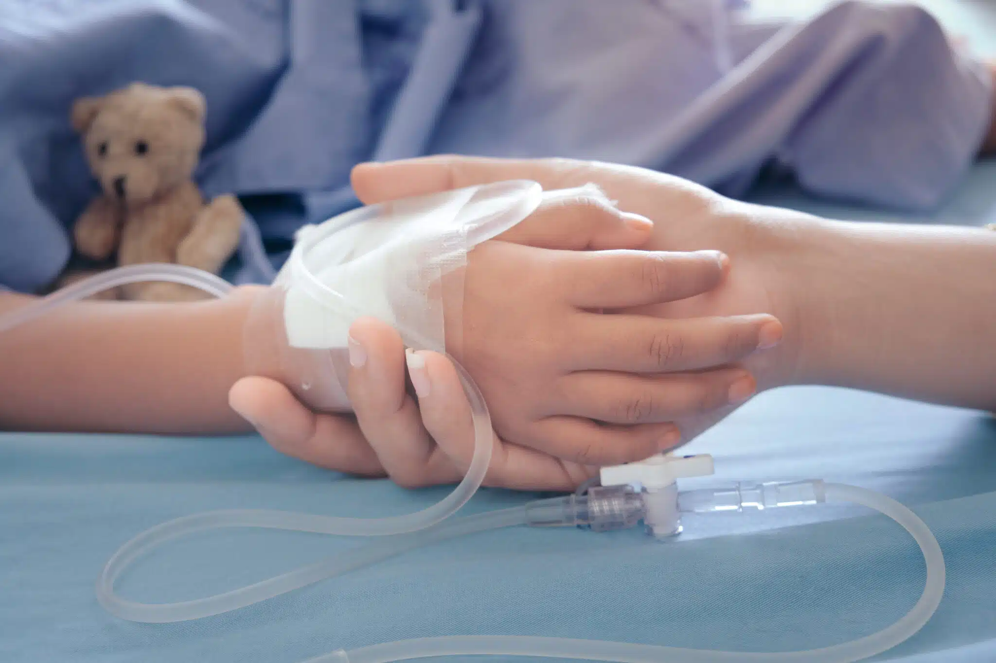 woman holding child's hand in hospital