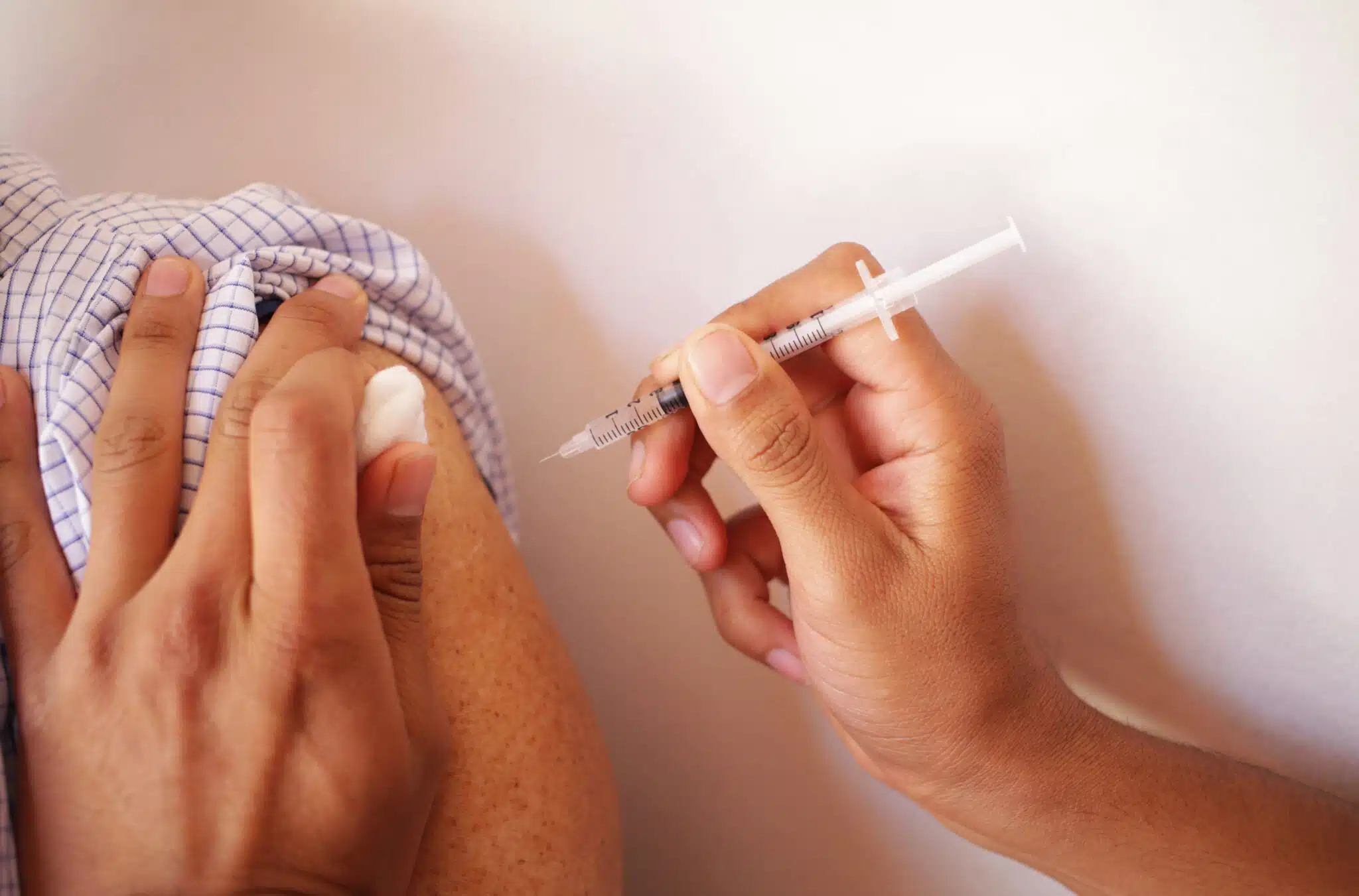 patient receiving shot in arm