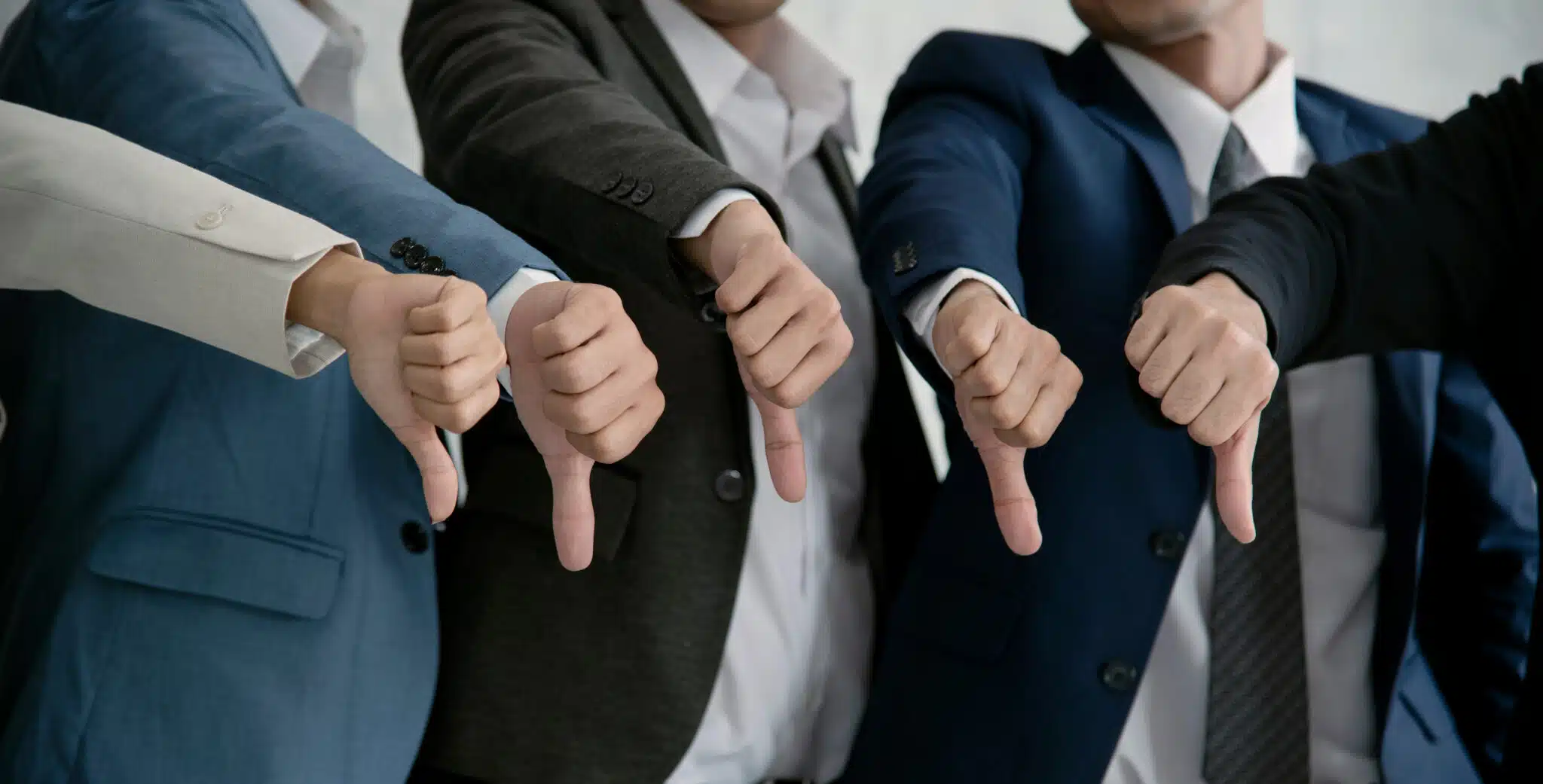 business people thumbs down