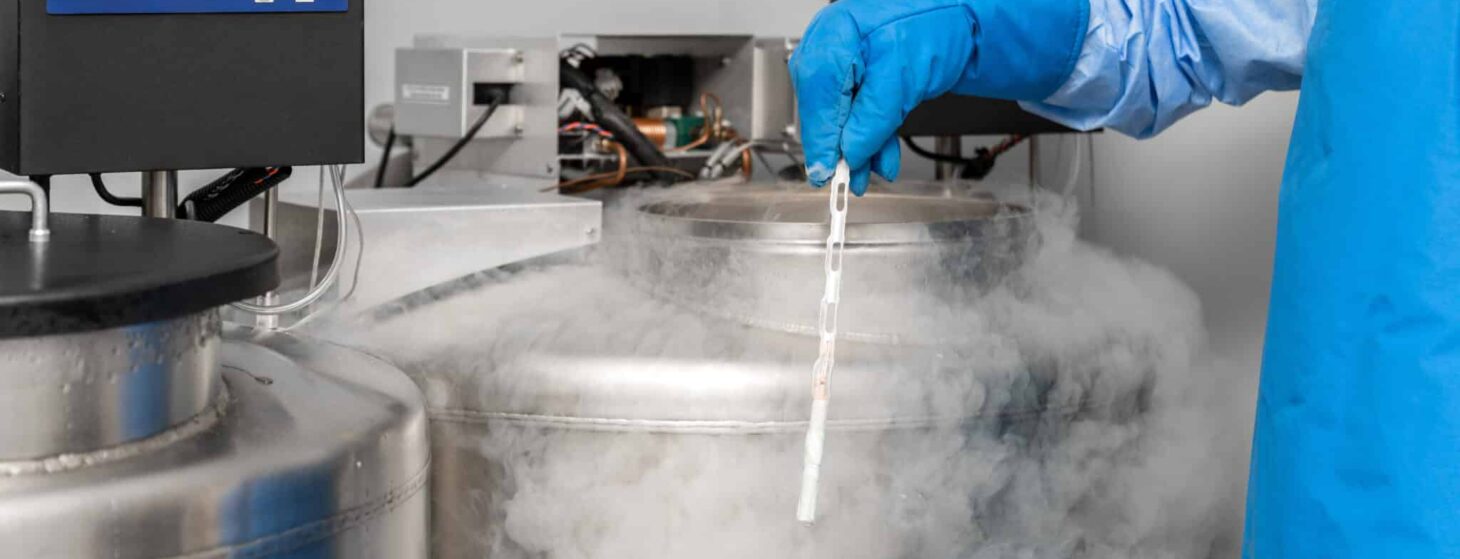 embryologist at a liquid nitrogen bank containing sperm and egg samples