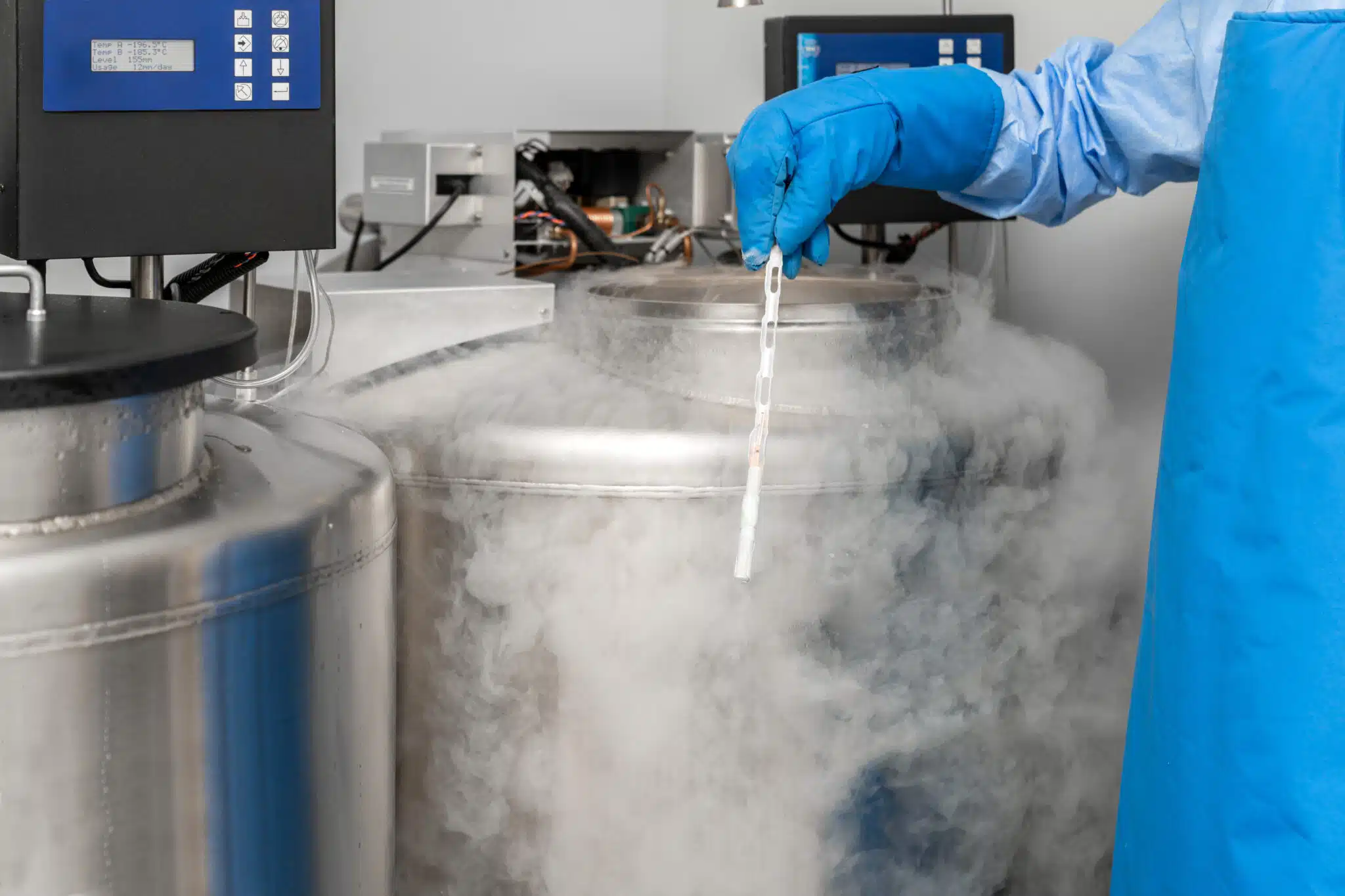 embryologist at a liquid nitrogen bank containing sperm and egg samples